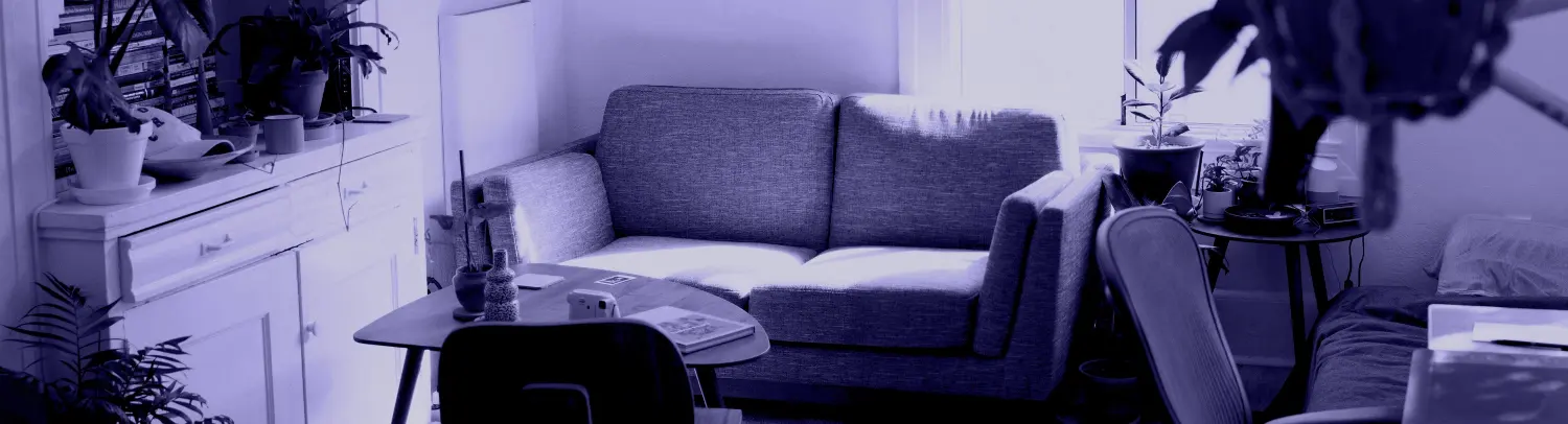 Office space with table, desk, sofa and cupboard